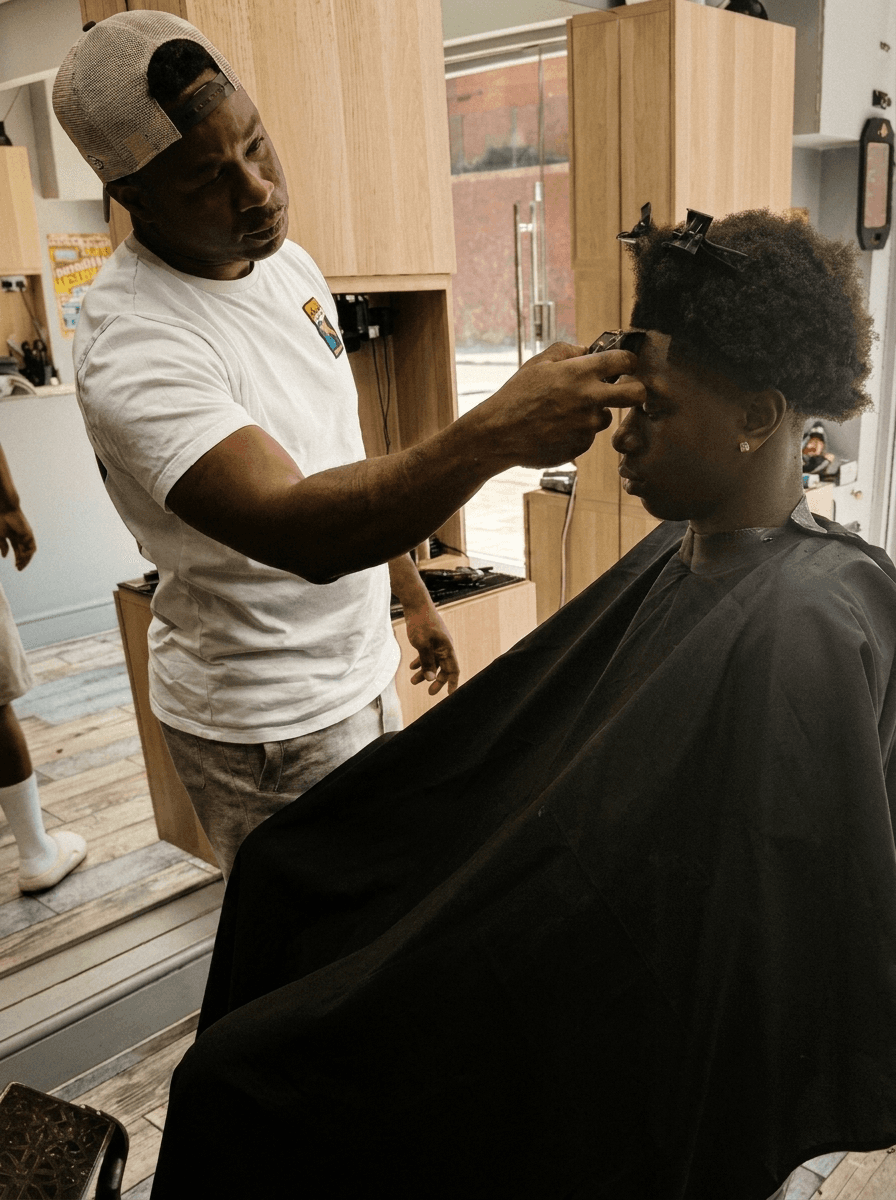 Baggio cutting a client's hair at Fresh Cutz Barbers, Wealdstone Harrow